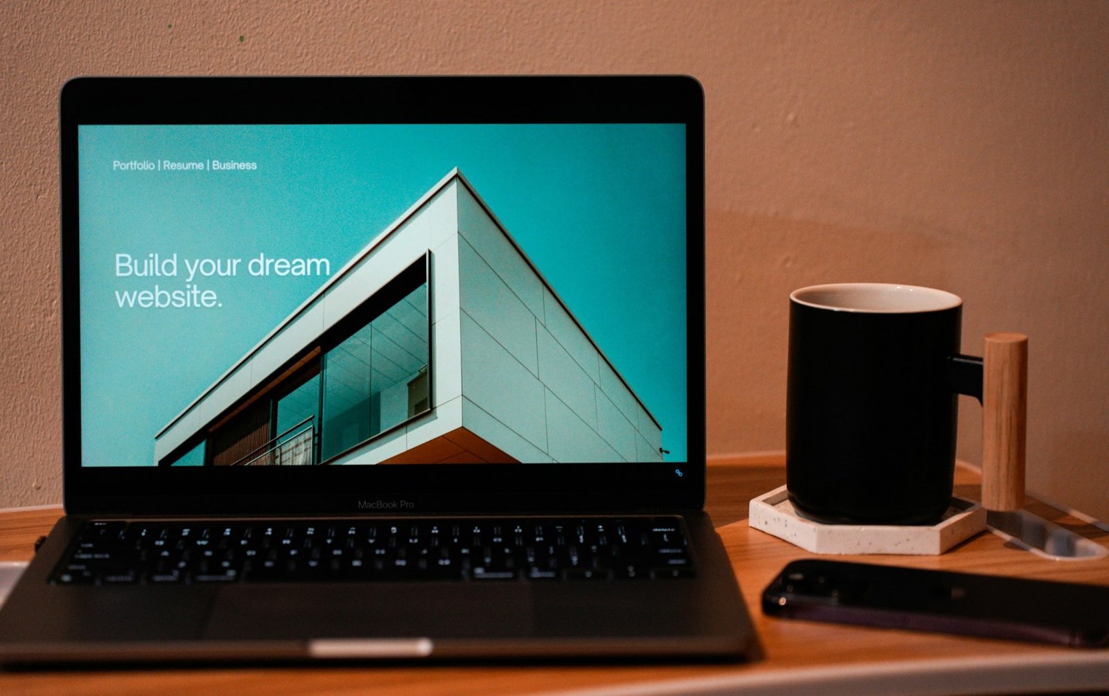 Laptop on a desk displaying a modern business website