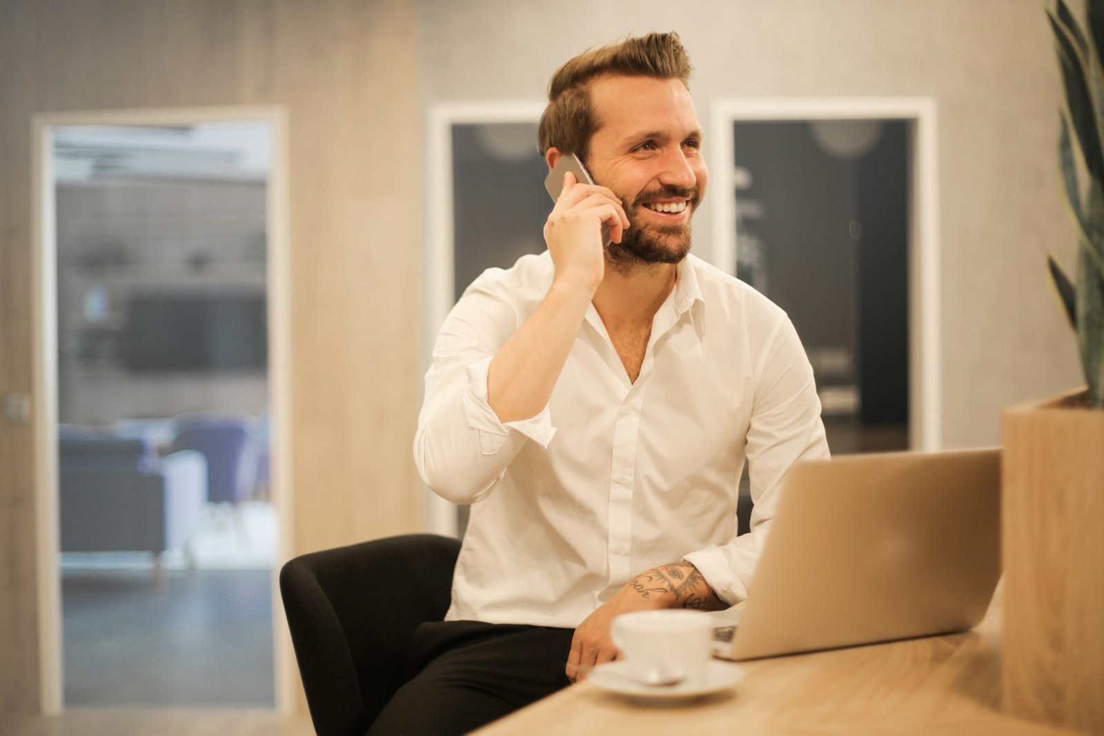 Smiling business owner working on a laptop in an office