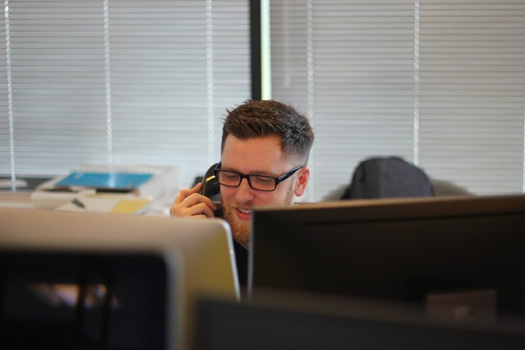 Business owner taking a sales call at his desk